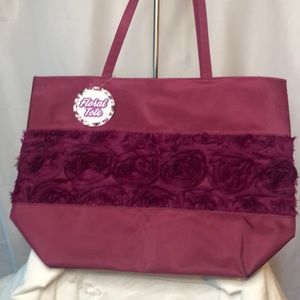 ARCADIA BEAUTY burgundy super large tote. Silk florals in front of bag.
